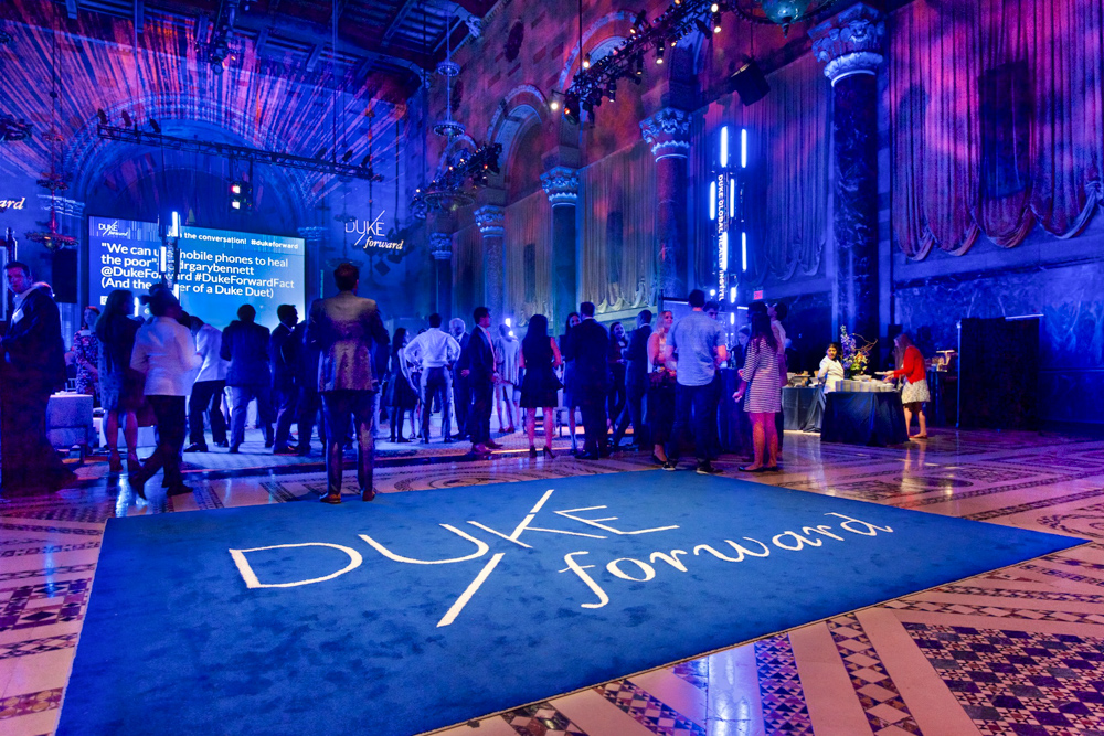 Guests mingling at the Duke Forward fundraising gala in an ornate ballroom