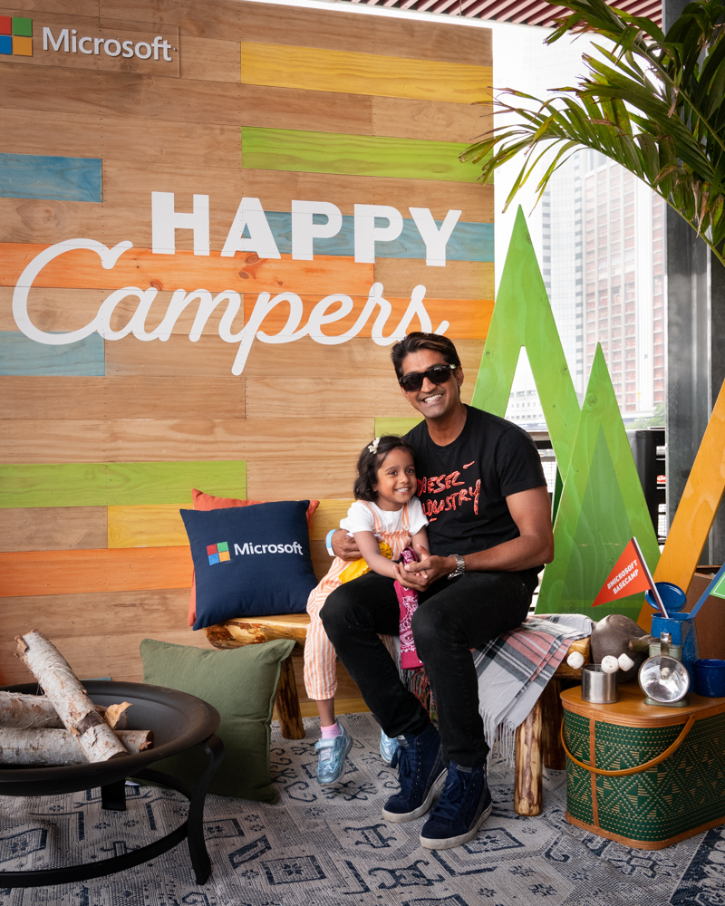 Man and young girl at Microsoft's Happy Campers event lounge